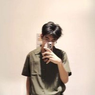 Mirror selfie of Jhestin in an olive button-up shirt.